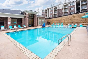 Resort-style swimming pool with sundeck for lounging